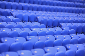 The empty blue plastic seat at stadium.