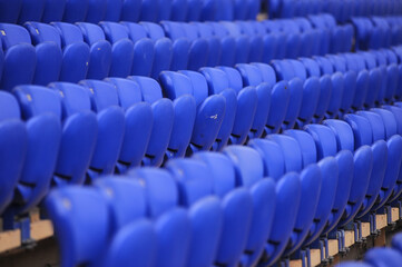 Fototapeta premium The empty blue plastic seat at stadium.