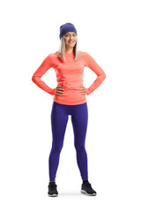 Full length portrait of a young woman in sport clothes and a hat