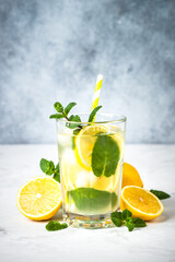 Lemonad in the glass at white table.