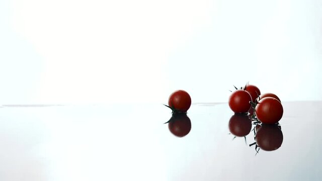 Red Tomato's rolling  on wet surface 
