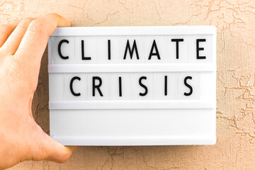 Climate crisis text message, climate changes concept background with letters on the lightbox