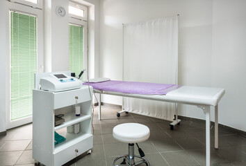 Physician Doctors Office with examination bed and therapy equipment