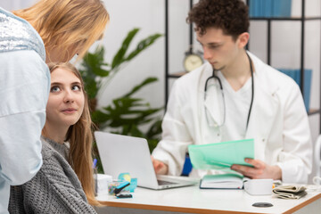 A mother explains to her daughter how she should handle what the doctor has told her about health. Doctor's office