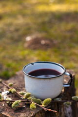 Take an enamel glass for tea or cocktails with you and on the road. For layout, nature background. 