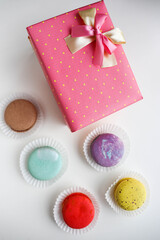 set of macaroons in a gift box and a bouquet of flowers 