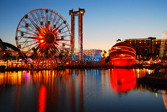 The Bright Colorful Lights Of Disney's California Adventure Amusement Park Is Reflected In The Lake