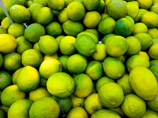 Lime in Fruit Market.Macro Photo citrus fruit lime.limes boxes in the store.Background from fresh lime.