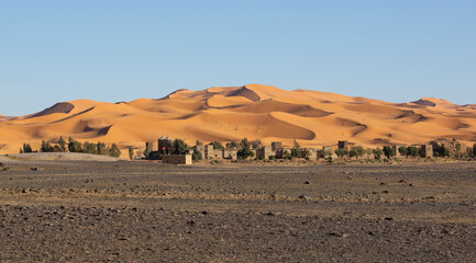 Fototapeta na wymiar village in the desert with dunes