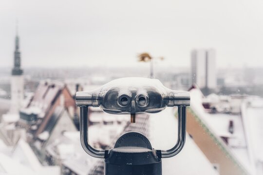 Close-up Of Coin-operated Binoculars Against Cityscape