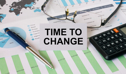 Business Card with text Time To Change with calculator white pen eyeglasses on the diagrams