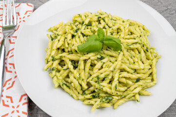 Pasta and pesto. Typical Italian dish of traditional Genoese cuisine (Liguria). Trofie with homemade pesto. Fresh pasta with pesto.