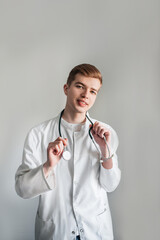 Studio shot of young doctor guy student in the clinic in practice