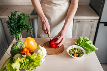male hands chopping salad and onion, cooking healthy food in the kitchen.