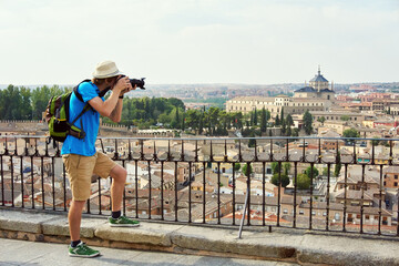 man traveler in a hat with a backpack and camera - 427739299