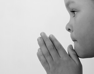 boy praying to God with hands together on white background stock photo