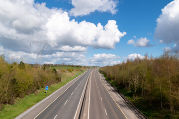 Countryside lanscape. Empty motorway and cloudy sky .