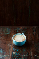 Cappuccino on dark wooden background. Copy space.	