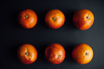 sicilian orange cut into pieces.
citrus, vitamins, on a dark background. wooden board. Healthy Eating.
food for rest. vegetarianism