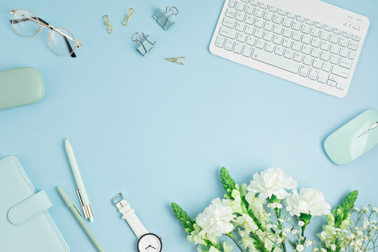 Home office desktop and flowers. Modern workspace with notebook, office stationary. Freelance business, organization, wedding planning flat lay