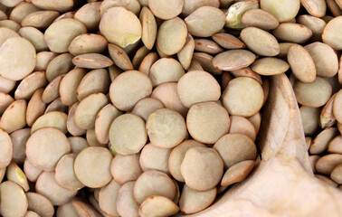 organic dried lentils in wooden spoon
