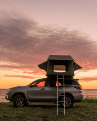 Fototapeta na wymiar Sunset on the beach camping in vehicle