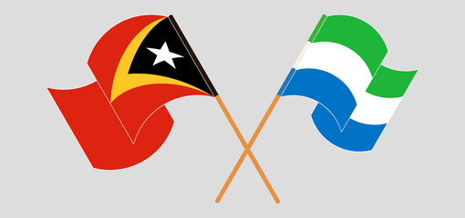 Crossed and waving flags of East Timor and Sierra Leone