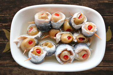 anchovies with olives, appetizer on the table
