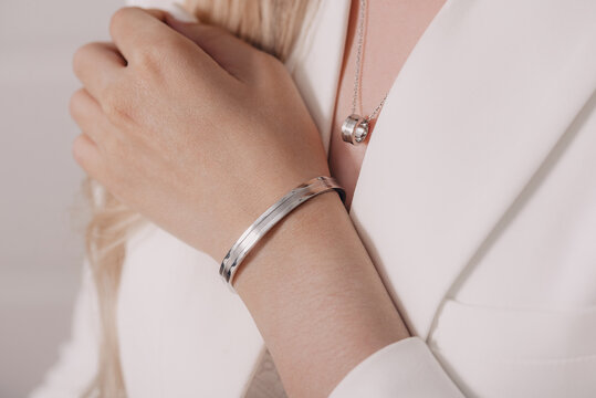 Woman wearing elegant pendant necklace and bracelet on close-up