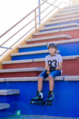 Preteen sitting on some bleachers equipped to skate.