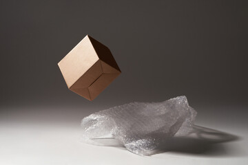 Close-up of cardboard box and bubble wrap on dark background