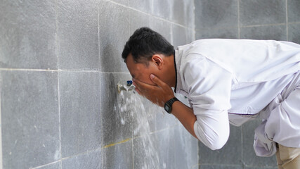 A portrait of an asian muslim ablution at mosque before pray
