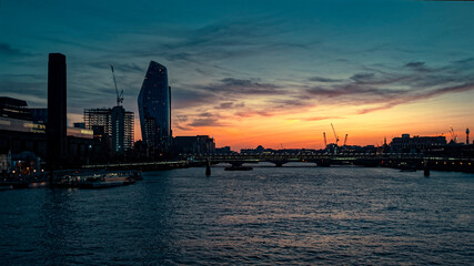 Fototapeta na wymiar Sunset over The River Thames and The Millennium Bridge, London England