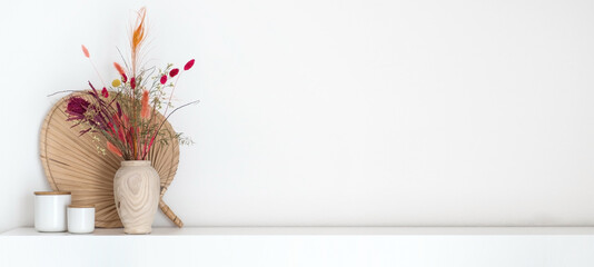 Colourful dried flower bouquet standing on a white shelf