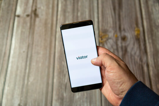 04-13-2021 Portsmouth, Hampshire, UK A Mobile phone or Cell phone being held in a hand showing the viator app on screen