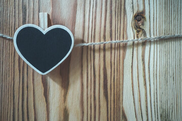 Wooden heart-shaped  nameplate on a rope, background - 427755044
