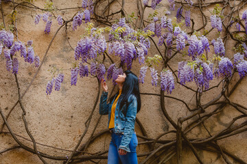 girl feeling nature smelling flowers