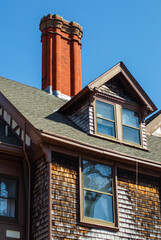 Bright orange brick chimney on pretty old house