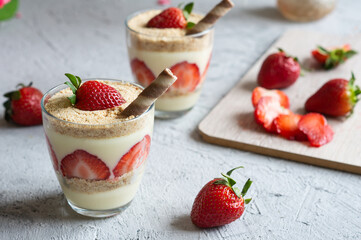 Magnolia dessert with fresh strawberries in glass cup, homemade milky dessert concept