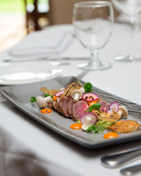 Sliced Beef With Decoration Served On A Long Plate. Food Styling And Restaurant Meal Serving