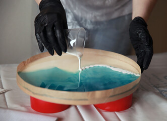 liquid art workshop, epoxy resin is poured on the surface. Master class, hobby.