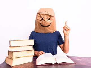Happy mature man finding the solution to what he was looking for in a book pointing with his finger, isolated on background.