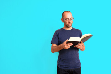 Man reads a book concentrated and expression on his face, isolated on white background.