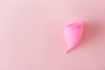 Menstrual cup on pink background. Top view, flat lay, copy space