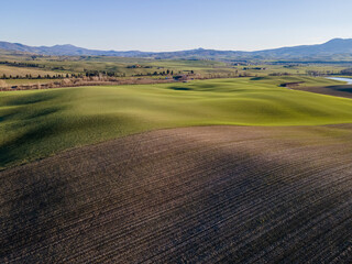 Scenic view of an idyllic countryside with rolling hills.  Aerial view, drone shot.