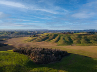 Scenic tuscan countryside in winter at sunset. Aerial view, drone shot.