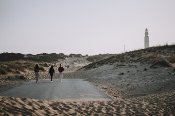 Group of people walking at the beach near the Cape Trafalgar lighthouse