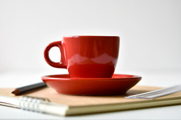 Red coffee cup on sketchbook with pencil and ruler is elements.