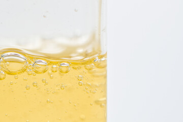 Close-up view, Texture of a yellow shampoo gel in a plastic bottle.