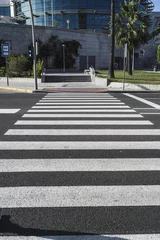 Fototapete Rund Vertical shot of zebra crossing on a sunny day outdoors © Miguel Angel Junquera/Wirestock